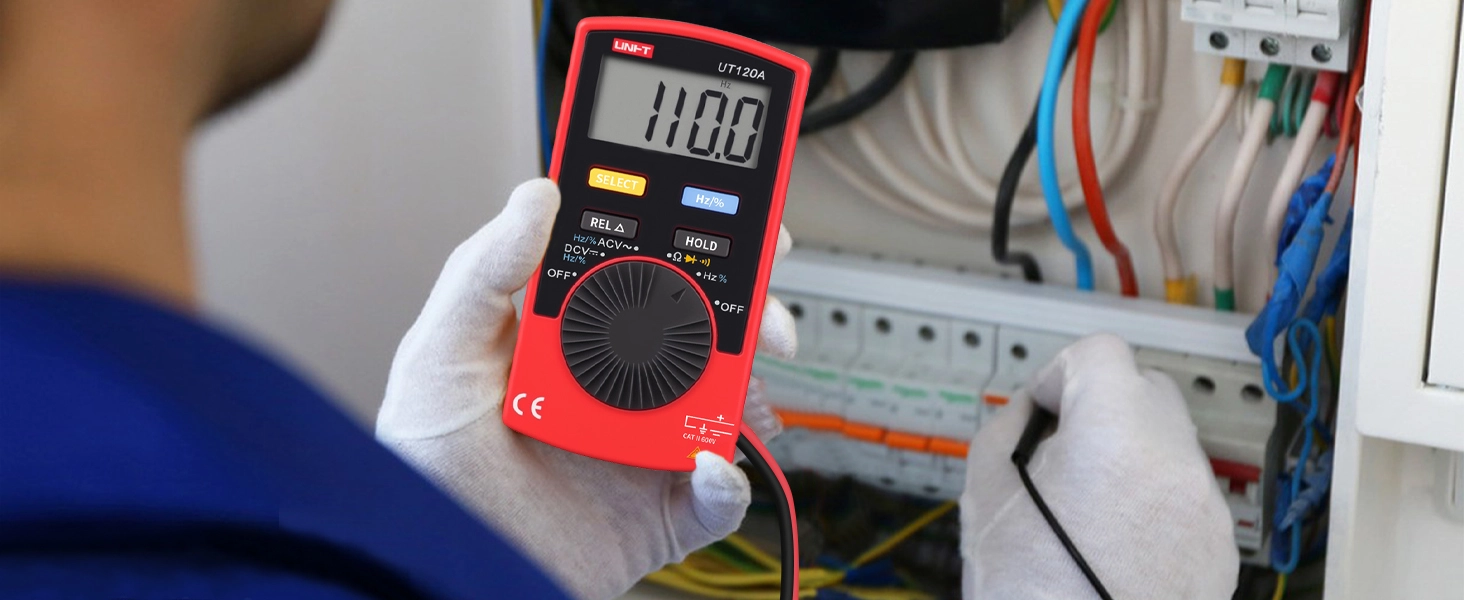 Technician using UNI-T UT120A multimeter to test electrical panel voltage